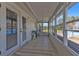 Enclosed back patio with tile flooring, large windows, and views of the backyard and pool at 628 Tarpon Way, Punta Gorda, FL 33950