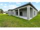 Exterior backyard view with gray home and covered patio at 12156 Wellington Ave, Port Charlotte, FL 33981