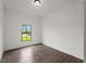Bedroom featuring wood-look tile flooring, white walls, and a window at 12156 Wellington Ave, Port Charlotte, FL 33981