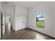 Bright bedroom featuring a large window, closet, and wood-look flooring at 12156 Wellington Ave, Port Charlotte, FL 33981