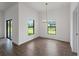 Bright dining room with tile flooring, modern chandelier, and large windows showcasing the outdoor scenery at 12156 Wellington Ave, Port Charlotte, FL 33981