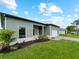Charming gray home with a manicured lawn and attached garage at 12156 Wellington Ave, Port Charlotte, FL 33981