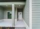 Inviting front porch with modern support columns and a stylish front door at 12156 Wellington Ave, Port Charlotte, FL 33981