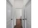 Hallway featuring tile floors, white trim, and open doorways leading to other rooms in the home at 12156 Wellington Ave, Port Charlotte, FL 33981