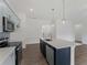 Beautiful kitchen with stainless steel appliances, pendant lighting, and a spacious island at 12156 Wellington Ave, Port Charlotte, FL 33981