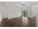 Spacious living room with sliding glass doors and tile floors, offering a bright and airy space at 12156 Wellington Ave, Port Charlotte, FL 33981