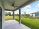 Covered patio with ceiling fan overlooks the fenced backyard at 12156 Wellington Ave, Port Charlotte, FL 33981