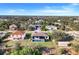 Aerial view of the property's backyard featuring a screened-in pool and green space at 14319 Allensworth Ave, Port Charlotte, FL 33981