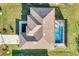 Aerial view of the house showcasing the roofline and screened-in pool area at 14319 Allensworth Ave, Port Charlotte, FL 33981