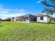 Lush backyard showing a screened-in lanai and well-maintained lawn at 14319 Allensworth Ave, Port Charlotte, FL 33981