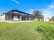 Expansive backyard featuring a screened-in lanai and ample green space at 14319 Allensworth Ave, Port Charlotte, FL 33981