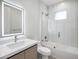 Well-appointed bathroom featuring a single sink, lighted mirror and glass shower/tub combination at 14319 Allensworth Ave, Port Charlotte, FL 33981