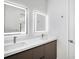 Modern bathroom with double sink vanity, quartz countertops, and stylish lighted mirrors at 14319 Allensworth Ave, Port Charlotte, FL 33981