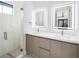 Elegant bathroom featuring double sinks, quartz countertops, and modern, lighted mirrors at 14319 Allensworth Ave, Port Charlotte, FL 33981