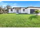 Charming single-story home boasts a lush front lawn and inviting entryway at 14319 Allensworth Ave, Port Charlotte, FL 33981