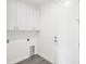 Clean laundry room with sleek cabinetry, appliances hookups and tile flooring at 14319 Allensworth Ave, Port Charlotte, FL 33981