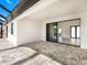 A covered patio with stone tile flooring, leading to an interior space at 14319 Allensworth Ave, Port Charlotte, FL 33981