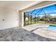 Covered patio overlooking the screened-in pool and backyard, filled with sunshine at 14319 Allensworth Ave, Port Charlotte, FL 33981