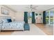 Bright bedroom features neutral walls, light wood floors and a ceiling fan at 14640 Sycamore Ct # 2812, Punta Gorda, FL 33955
