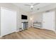 Bright bedroom with hardwood floors, closet, ceiling fan, and mounted tv at 14640 Sycamore Ct # 2812, Punta Gorda, FL 33955