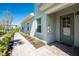 The side of the house with a walkway, manicured shrubs, and a door at 14640 Sycamore Ct # 2812, Punta Gorda, FL 33955