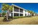 White two-story building surrounded by lush landscaping at 14640 Sycamore Ct # 2812, Punta Gorda, FL 33955