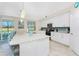 Bright eat-in kitchen featuring granite counters, an island with seating, and stainless appliances at 14640 Sycamore Ct # 2812, Punta Gorda, FL 33955
