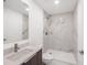 Bathroom with modern tile shower, gray vanity, white counters, and recessed lighting at 16440 Cape Horn Blvd, Punta Gorda, FL 33955