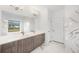 Elegant bathroom with double vanity, marble tile, soaking tub and large window view at 16440 Cape Horn Blvd, Punta Gorda, FL 33955