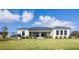 This home features a black roof, a well manicured lawn, and freshly planted green bushes at 16440 Cape Horn Blvd, Punta Gorda, FL 33955