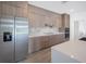 A modern kitchen featuring stainless steel appliances, quartz countertops, and wood cabinets at 16440 Cape Horn Blvd, Punta Gorda, FL 33955