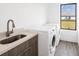 This laundry room features a sink, counter, washer and dryer, and neutral walls at 16440 Cape Horn Blvd, Punta Gorda, FL 33955