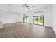Bright living room features tile floors, ceiling fan, and sliding glass doors with transom windows at 16440 Cape Horn Blvd, Punta Gorda, FL 33955