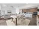 A spacious open-concept design with a dining area, living room, and modern kitchen, showcasing the home's contemporary style at 16440 Cape Horn Blvd, Punta Gorda, FL 33955