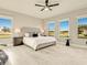 Stylish main bedroom features a ceiling fan, bright windows, and a comfortable rug at 16440 Cape Horn Blvd, Punta Gorda, FL 33955