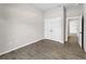 Cozy bedroom with wood-look flooring, spacious closet and neutral wall color at 17323 Elmwood Ave, Port Charlotte, FL 33948