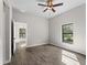 Bedroom with wood-look tile flooring, neutral walls and view to adjacent rooms at 17323 Elmwood Ave, Port Charlotte, FL 33948
