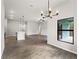 Bright dining area with modern chandelier, wood-look tile flooring, and large windows overlooking the backyard at 17323 Elmwood Ave, Port Charlotte, FL 33948