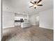 Spacious open-concept living area with tile flooring, a ceiling fan, pendant lighting, and a modern kitchen island at 17323 Elmwood Ave, Port Charlotte, FL 33948