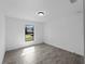 Bright and airy bedroom with natural light, showcasing neutral walls and tile flooring at 17331 Elmwood Ave, Port Charlotte, FL 33948