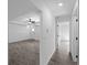 Open-concept living room with tile flooring, ceiling fan, and a welcoming, airy atmosphere at 17331 Elmwood Ave, Port Charlotte, FL 33948