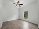 Bedroom with a ceiling fan, bright window and neutral paint at 17339 Elmwood Ave, Port Charlotte, FL 33948