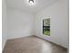 Bright bedroom featuring wood-look tile flooring and a window with a view at 17339 Elmwood Ave, Port Charlotte, FL 33948
