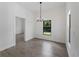 Dining room featuring a modern chandelier, neutral paint and a bright window view at 17339 Elmwood Ave, Port Charlotte, FL 33948