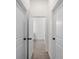 Hallway with white doors and trim and neutral-toned floors at 17339 Elmwood Ave, Port Charlotte, FL 33948