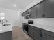 Sleek kitchen with modern gray cabinets, stainless steel appliances, quartz countertops, and a subway tile backsplash at 17339 Elmwood Ave, Port Charlotte, FL 33948