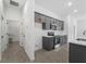 Modern kitchen with stainless steel appliances, gray cabinets, tile flooring, and ample counter space at 17339 Elmwood Ave, Port Charlotte, FL 33948