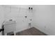 Functional laundry room with a utility sink, storage shelf, and tile flooring at 17339 Elmwood Ave, Port Charlotte, FL 33948