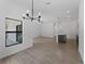 Open living room featuring a kitchen island, neutral paint, and views of the outdoors at 17339 Elmwood Ave, Port Charlotte, FL 33948