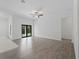 Bright living room with tile floors, ceiling fan, and sliding glass doors leading to the backyard at 17339 Elmwood Ave, Port Charlotte, FL 33948